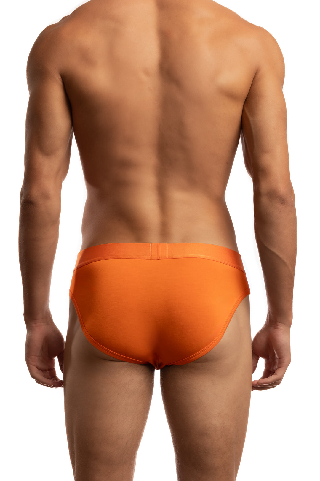 Shirtless man standing in front of a white background wearing a pair of Jack Adams Bamboo Briefs in orange (back view)