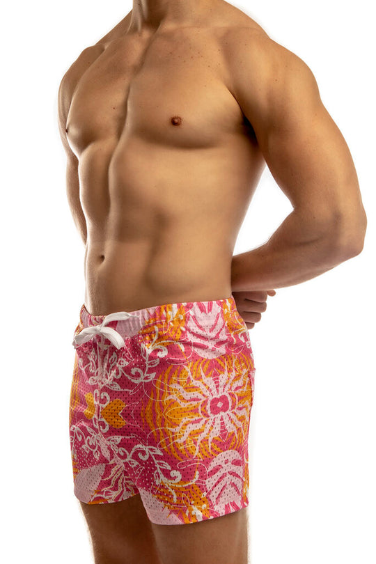 Man standing wearing a pair of Jack Adams tropic pink Freestyle Mesh Shorts (profile view) on a white background.