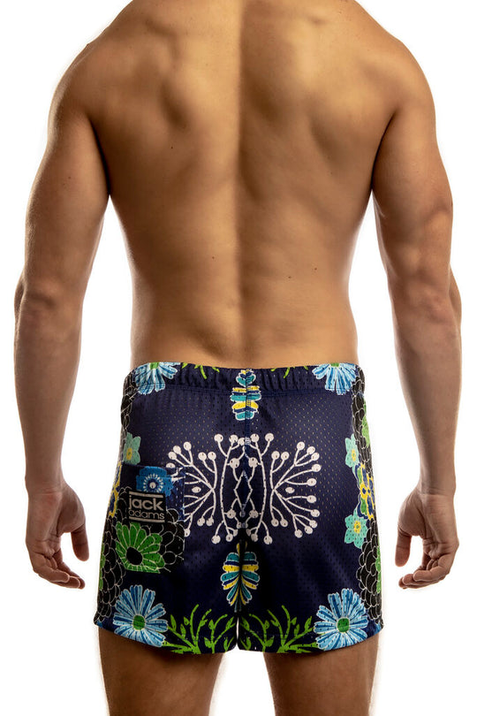 Man standing wearing a pair of Jack Adams japanese flower-  royal Freestyle Mesh Shorts (back view) on a white 