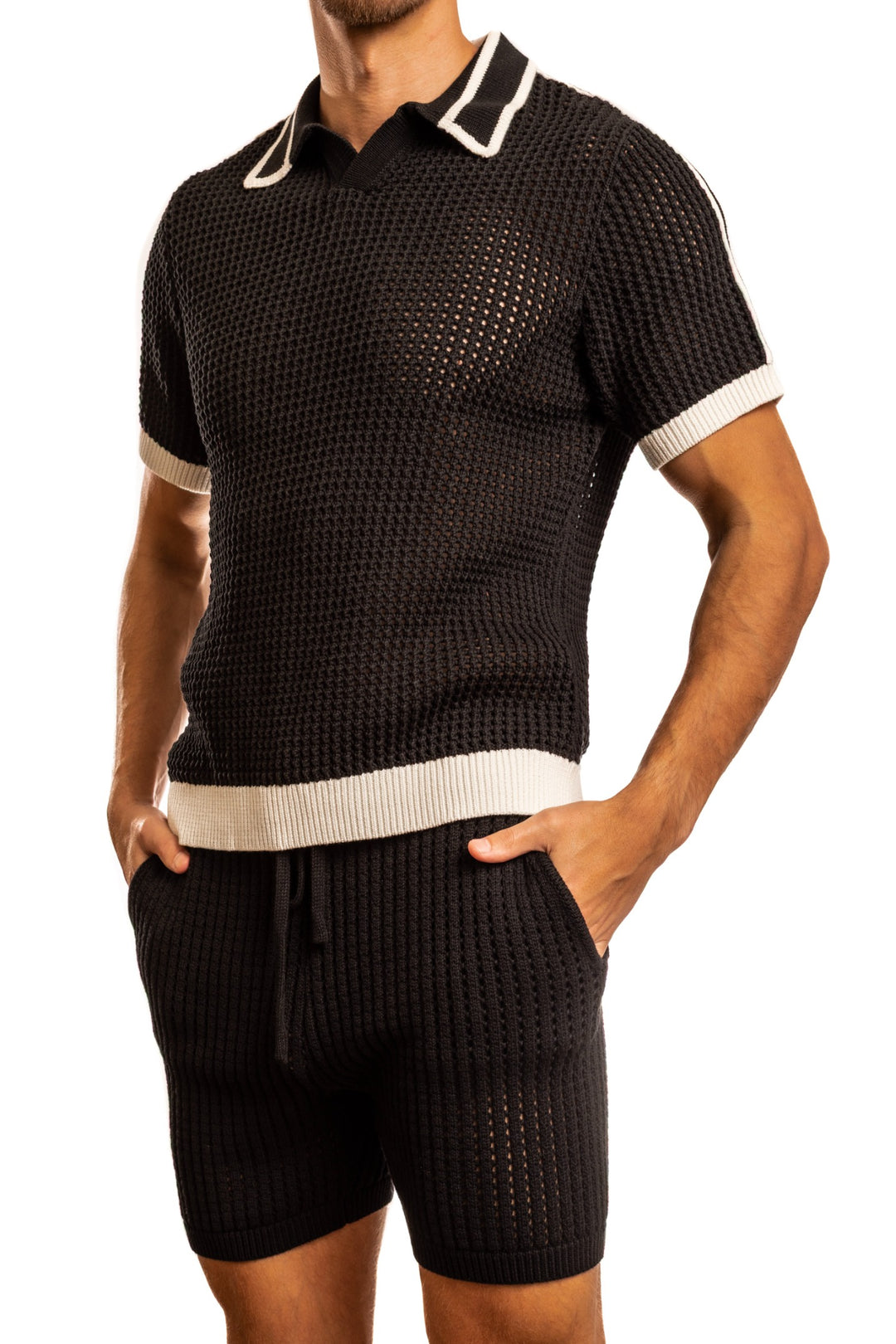 Man standing wearing a pair of Jack Adams black Matteo Crochet Knit Pull Over Shirt (profile view) on a white background.