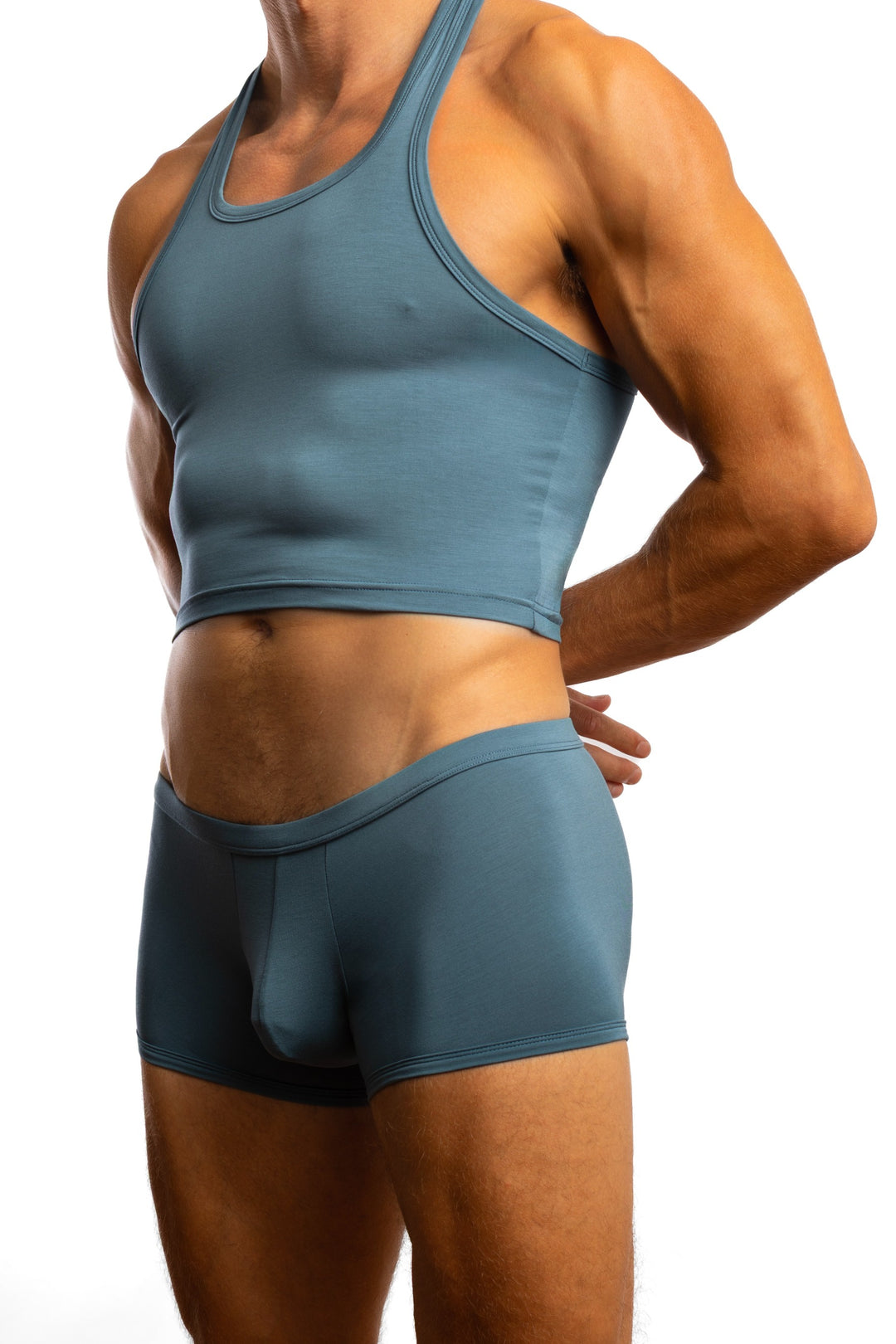 Shirtless man standing in front of a white background wearing a pair of Jack Adams In Intimo Cropped Modal Tank in blue silver (profile view)