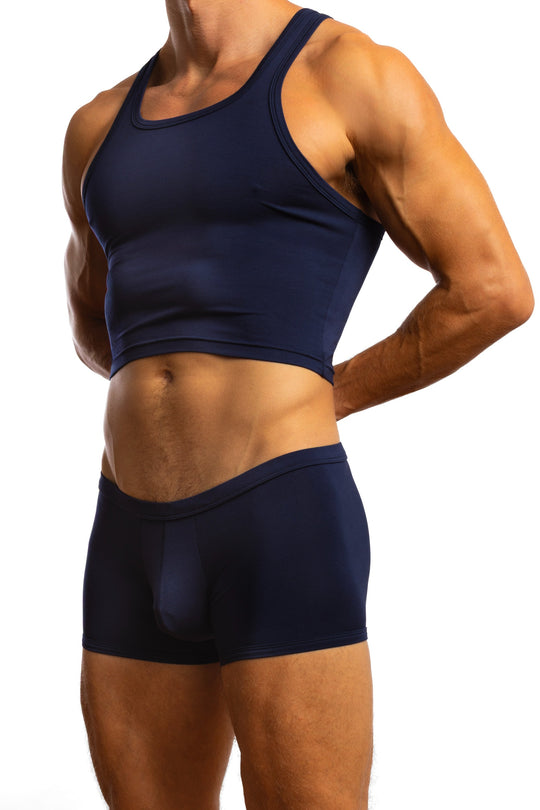 Shirtless man standing in front of a white background wearing a pair of Jack Adams In Intimo Cropped Modal Tank in midnight blue (profile view)
